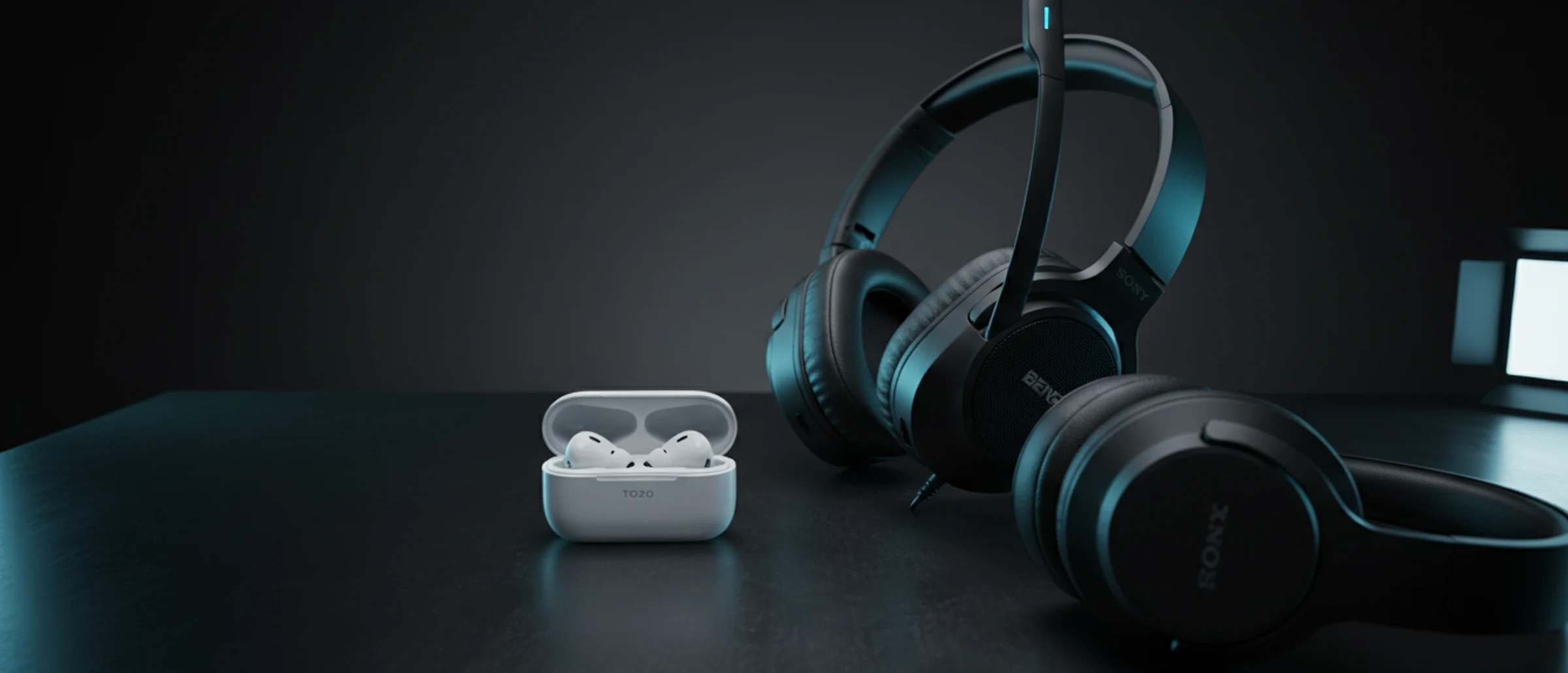 Tres auriculares distintos —earbuds TOZO, headset gamer negro y over-ear Sony— iluminados en estudio oscuro con luz lateral, apoyados sobre una mesa de aluminio.